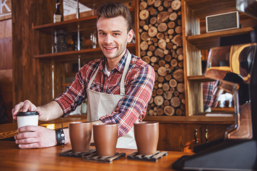 Barista serving coffee at a cafe